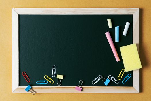 School supplies on black board background. Back to school concept