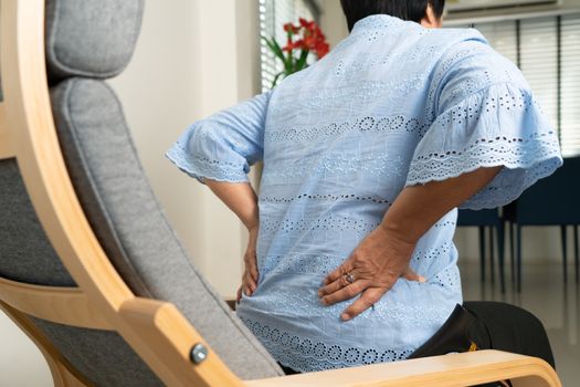 Old woman back pain at home, health problem concept