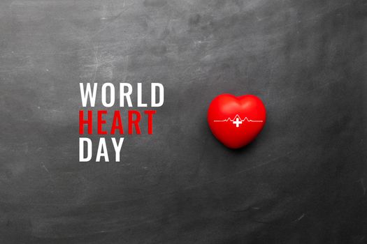 World heart day concept, a red heart on black background