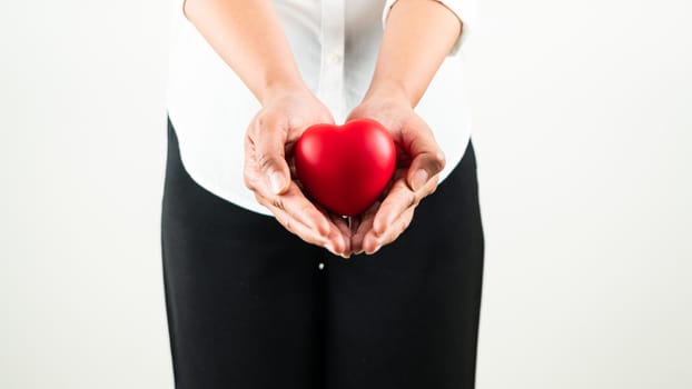 World heart day concept of young woman hand holding red heart