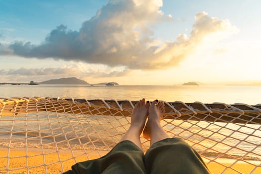 Beautiful beach. girl legs laying down on the  beach font near the sea. Summer holiday and vacation concept