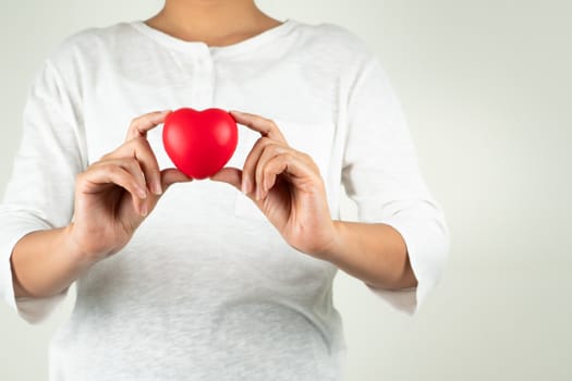 World heart day concept of young woman hand holding red heart