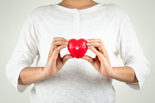 World heart day concept of young woman hand holding red heart