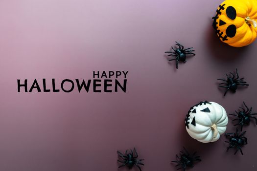 Happy Halloween, horror pumpkin and scary spider on purple background