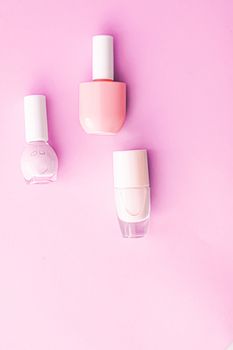 Nail polish bottles on pink background, beauty branding