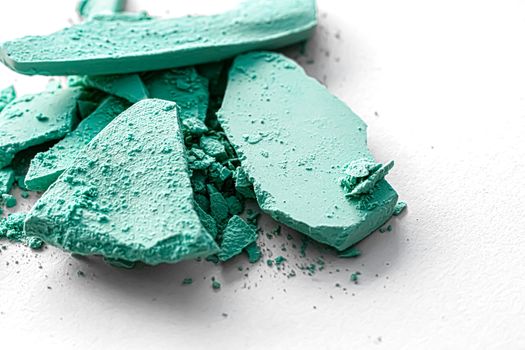 Mint eye shadow powder as makeup palette closeup isolated on white background, crushed cosmetics and beauty textures