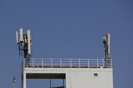 Antenna on the rooftop of a residential building. Cellular mobile phone antenna