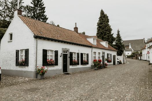 Street in the historic city of Thorn in Limburg, the Netherlands. Known for its white houses. also called the white city, it was painted white because of tax rules in the ancient times