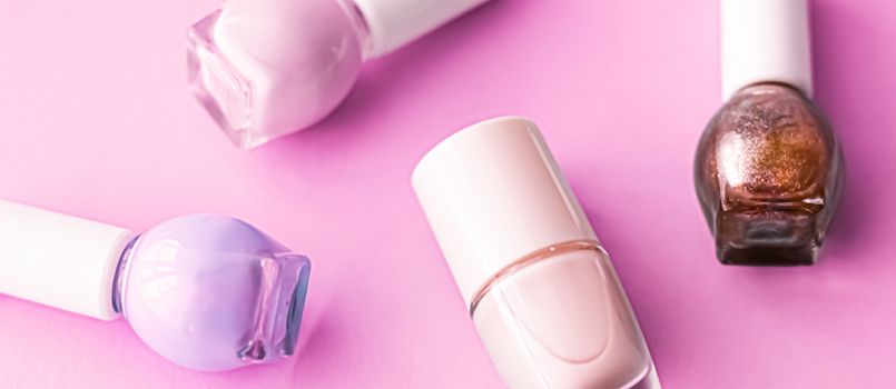 Nail polish bottles on pink background, beauty branding