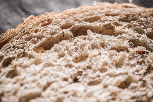 Fresh whole grain seeded bread, organic wheat flour, closeup slice texture as background for food blog or cook book recipes