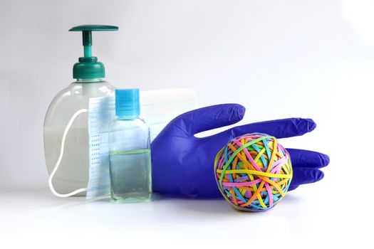 Protective face mask, soap, antiseptic, gloves against virus on white background with colorful symbol of planet