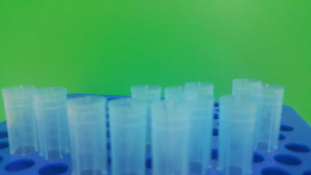 Close up view of blue micro litre tips in microtip box with empty holes. Reseach lab. tool for accurate measurement.