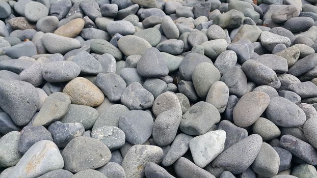 Texture background: Rock Pebbles, small, rounded, smooth pibbles with copy space for text
