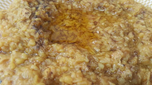 A close up view spicy daal dish served with ghee on it. Traditional Asian home made spicy lentil or daal dish
