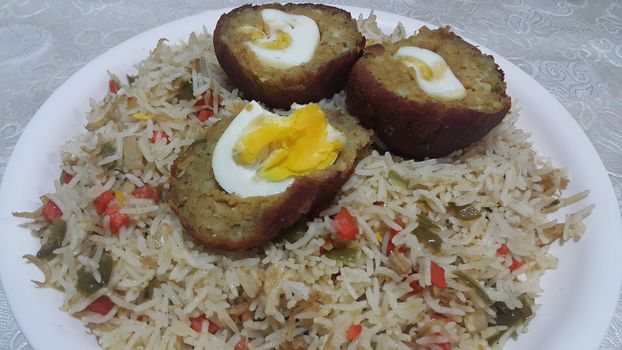 Top view of meat balls or meat kofta curry in Basmati rice pulao or pulav or vegetable rice dish