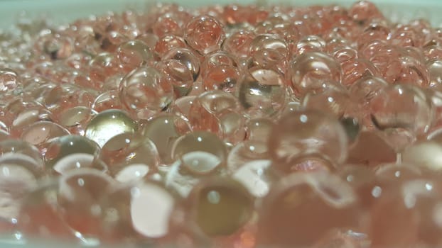 Closeup view with selective focus of shiny glittering orbeez or colorful water balls hydrogel. Water beads orbeez background.