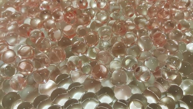 Closeup view with selective focus of shiny glittering orbeez or colorful water balls hydrogel. Water beads orbeez background.