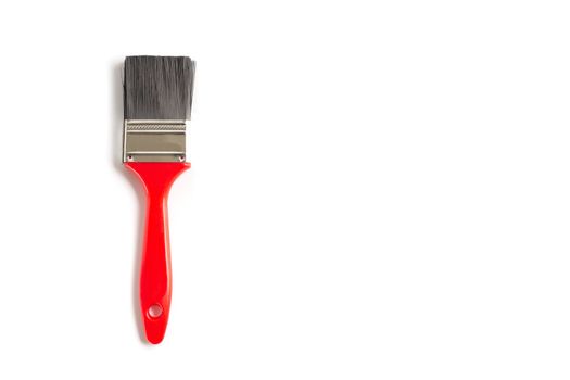 Brand new red paint brush isolated on a white background