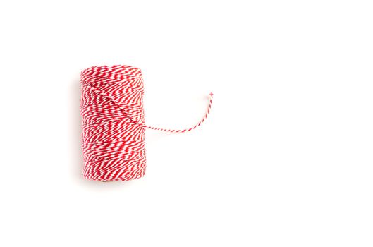 Red and white twine spool isolated on white background