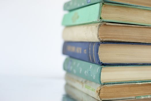 Stacked old books from cover side, soft focus, close up. Learning, reading, adventure of curiosity.