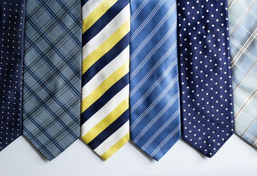 Many different colorful ties, on white background