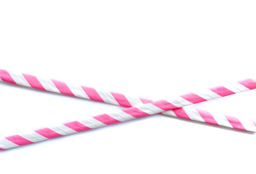 Two crossed red and white straws as symbol of protection warning, to catch attention, no entry tape on white background