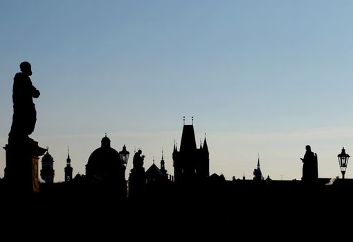 Sunset over Prague, Charles Karlov Bridge is famous attraction, world heritage site. Historic place of capital of Czech Republic, cultural center of Europe. Gothic, Renaissance and Baroque eras.