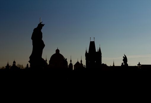 Sunset over Prague, Charles Karlov Bridge is famous attraction, world heritage site. Historic place of capital of Czech Republic, cultural center of Europe. Gothic, Renaissance and Baroque eras.