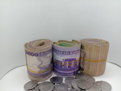 Bangladeshi bank note bundle and coin on white background