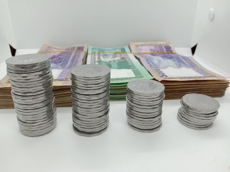 bangladeshi bank note and coin on white background