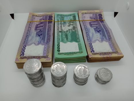 bangladeshi bank note and coin on white background