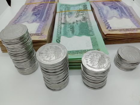 bangladeshi bank note and coin on white background