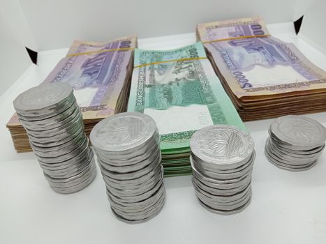 Bangladeshi bank note and coin on white background