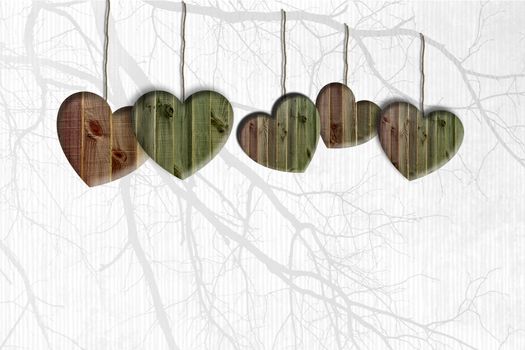 Horizontal border of holiday objects icons of wooden hearts hanging on string cord on soft focus twigs background. Happy Saint Valentines, wedding, love concept