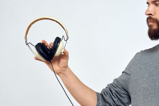 Man holding headphones in the hands of a man lifestyle modern style technology cropped view. High quality photo