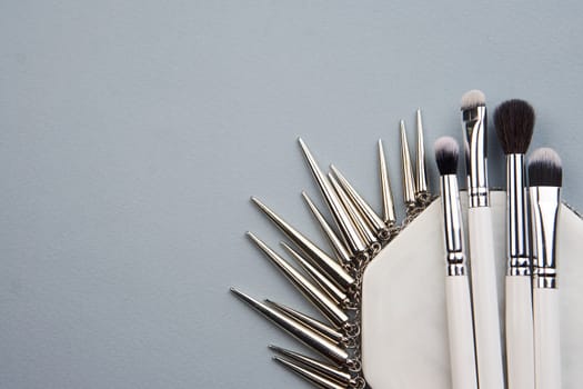 makeup brushes on gray background and stand cropped view Copy Space. High quality photo