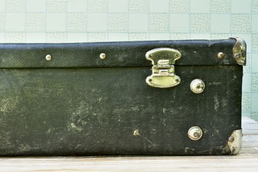 old black suitcase in a retro interior, back view