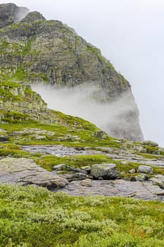 Fog, clouds, rocks and cliffs on Veslehødn Veslehorn mountain in Hemsedal, Norway.