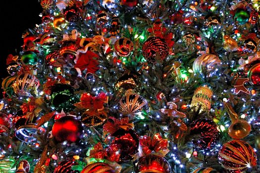 Many colorful ornaments on Christmas tree.Merry Christmas and Happy Holidays. A beautiful living room decorated for Christmas.festively decorated home interior with Christmas tree.beautiful ornaments