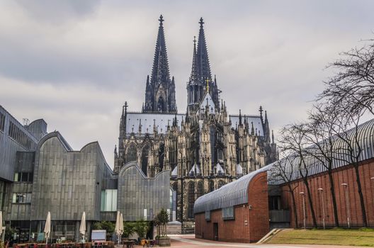 Shock of styles the Gothic of the German cathedral of Cologne dating to one thousand two hundred and forty-eight surrounded by modernist constructions