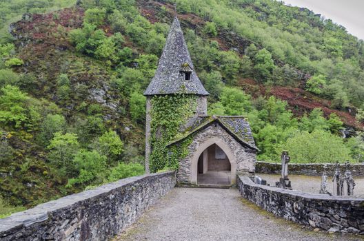 View of the chapel in the cemetery of the village of Conques which is located in the French region of Occitania in the valley of the river Dourdou de Conques