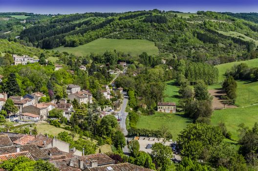 On the outskirts of the French village of St. Cirq Lapopie is this beautiful valley with all possible greens, last houses of the village and fields carved.