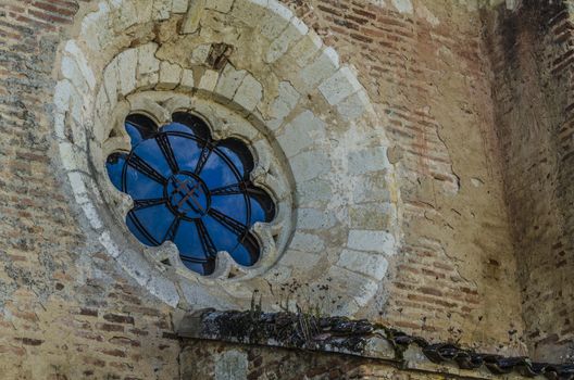 Detail of chapel window in the port of the medieval village of Auvillar, near the river Garonne, France.