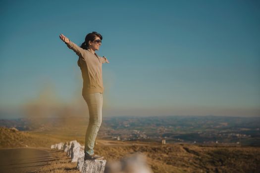 Woman enjoying the nature with arms raised
