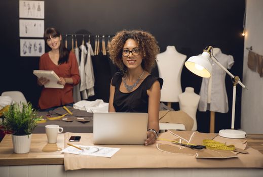 Two young entrepreneur women, and fashion designer working on her atelier