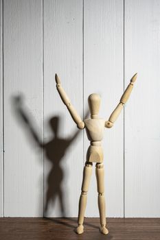 the  wooden mannequin with raised arms