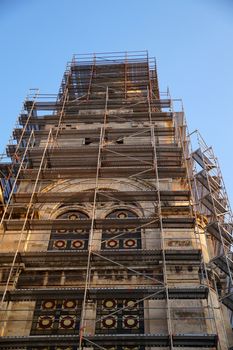 orthodox cathedral in scaffolding on a background of blue sky