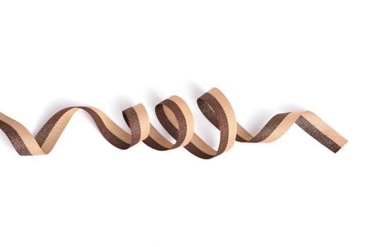 Brown beige Cotton ribbon, roll textilies on bobbin. strapping tape with curl on white backgroud. Use for sewing clothes, bags. Space for text.