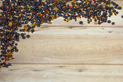 frame made of blueberries arranged around wooden background