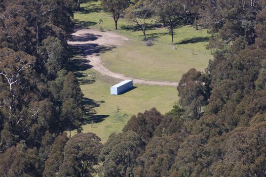 A large agricultural implement shed in a valley in the Central Tablelands in regional New South Wales in Australia